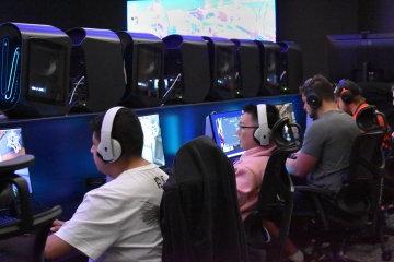 电子竞技项目的学生, seated in chairs at computer screens in the all-new eSports auditorium.